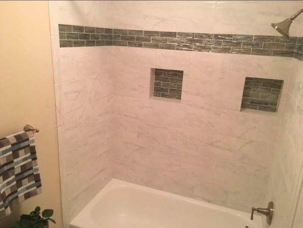 Modern bathroom featuring a sleek tub and unique tile accents for a contemporary feel.