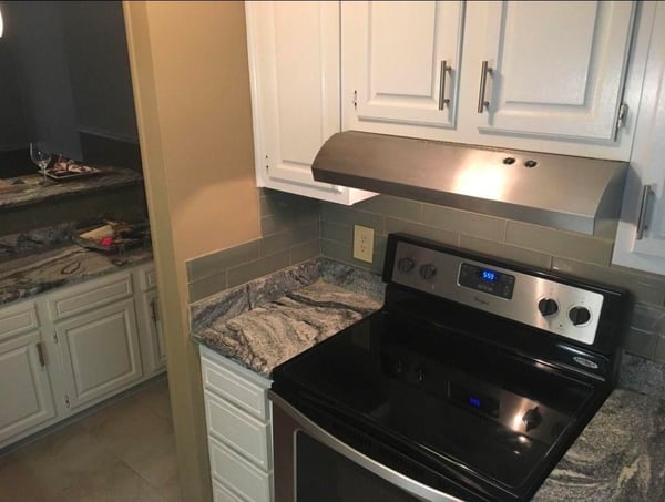 Modern kitchen featuring stainless steel appliances and sleek countertops, perfect for culinary enthusiasts and entertaining.