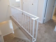 Bright and airy landing with modern railing, offering a welcoming entryway to the upper living spaces.