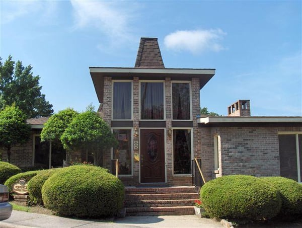 Unique architectural design featuring a striking facade and well-maintained landscaping in a welcoming neighborhood.