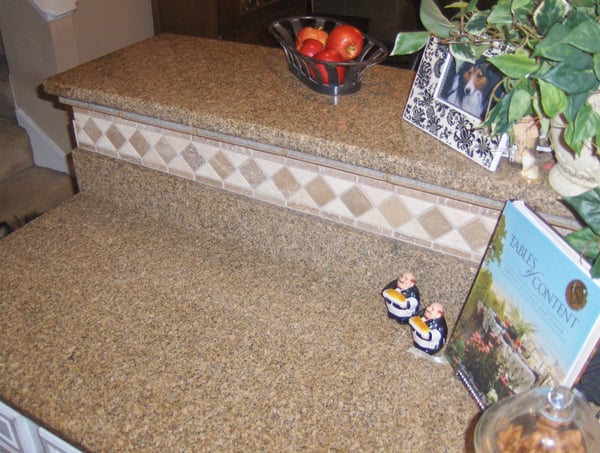 This well-appointed kitchen features a stunning granite countertop with decorative tile accents and thoughtful decor.