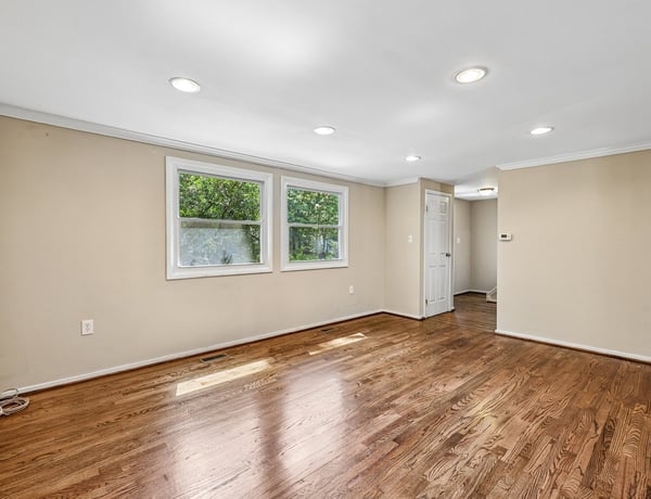 Spacious living area with ample natural light and newly refinished hardwood floors throughout. Perfect for customization!