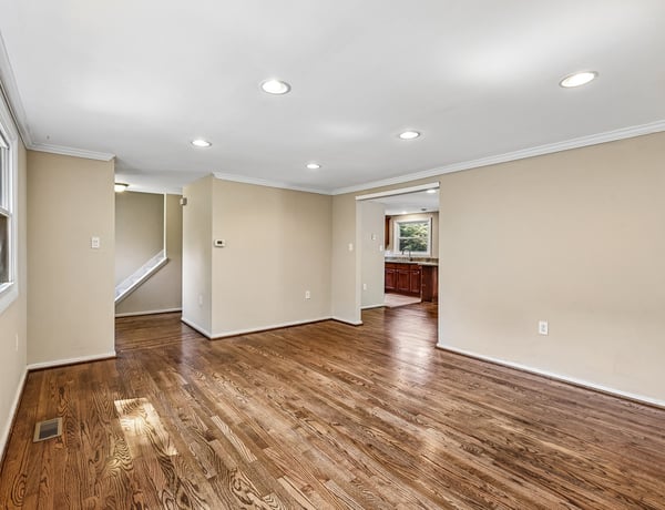 Spacious living area featuring hardwood floors, ample natural light, and an inviting open layout to the kitchen.