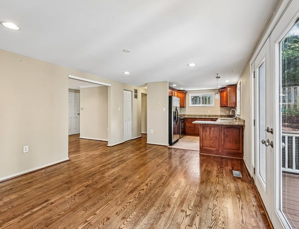 Spacious open layout featuring warm hardwood floors and a modern kitchen, perfect for entertaining.