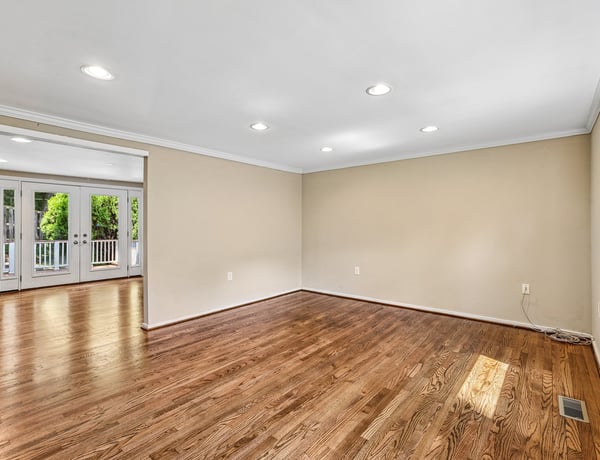 Bright, versatile space with hardwood floors, ideal for creative design and comfortable living.