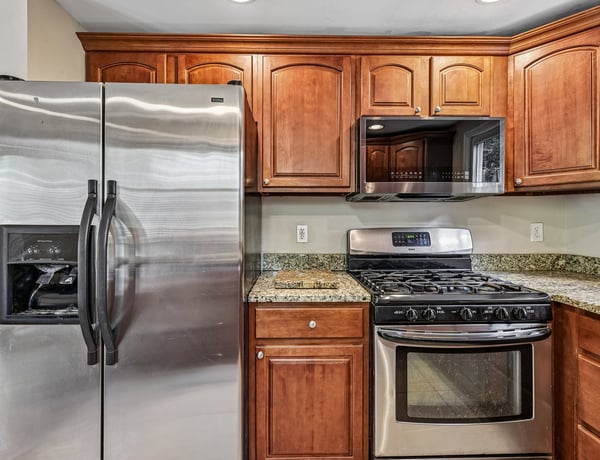Modern kitchen featuring stainless steel appliances, ample cabinetry, and granite countertops, perfect for culinary enthusiasts.