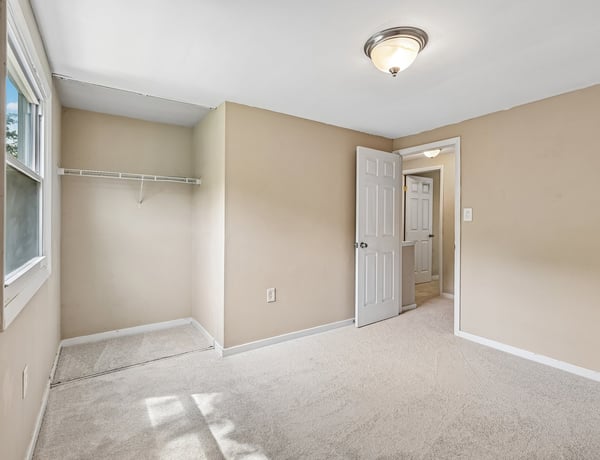 This versatile room features ample natural light, soft carpeting, and convenient access to nearby amenities.
