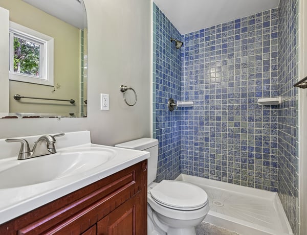 Modern bathroom featuring vibrant tile accents and functional layout for everyday convenience. Ideal for your home!