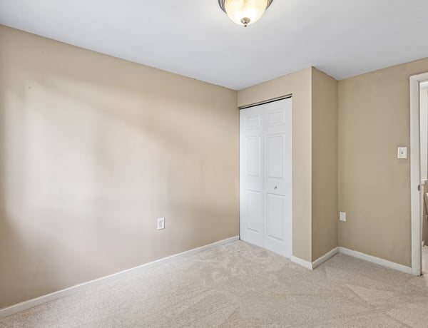 Bright, versatile room with ample natural light and built-in storage, ready for your personal touch.