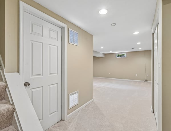 Spacious basement area featuring neutral colors, versatile layout, and abundant natural light for various uses.