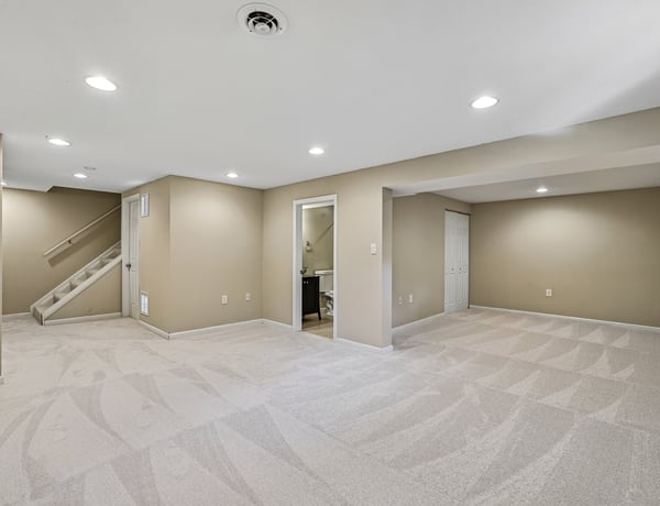 Spacious, versatile basement with neutral tones, perfect for a media room or additional living area.