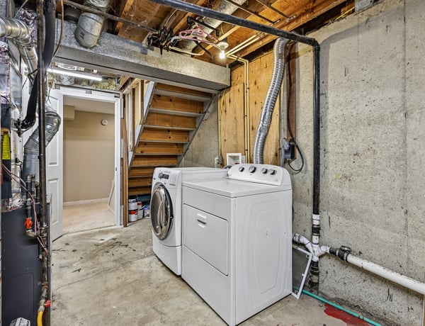 Spacious laundry area in the basement features modern appliances and ample storage for convenience.