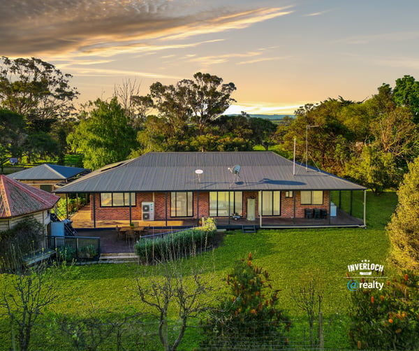 Spacious home set on lush grounds, featuring expansive outdoor areas and stunning views of the landscape.