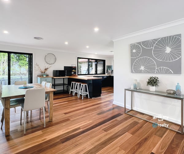 Spacious open-plan living area with modern finishes, large windows, and abundant natural light throughout.