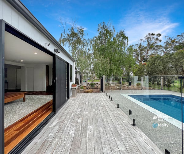 Modern home featuring open spaces, seamless indoor-outdoor flow, and a refreshing pool set amidst nature.