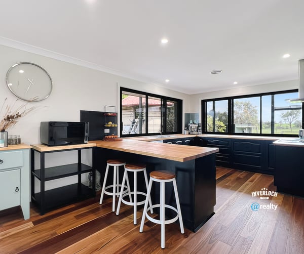 Bright and functional kitchen featuring modern appliances, ample counter space, and scenic views through expansive windows.