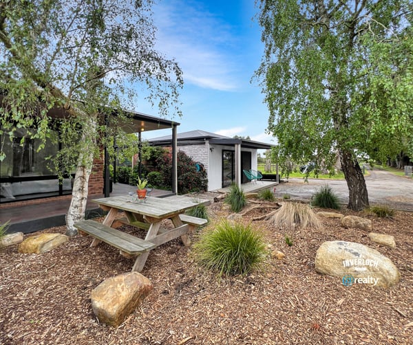 Discover a unique outdoor space featuring a picnic area surrounded by natural landscaping and modern amenities.