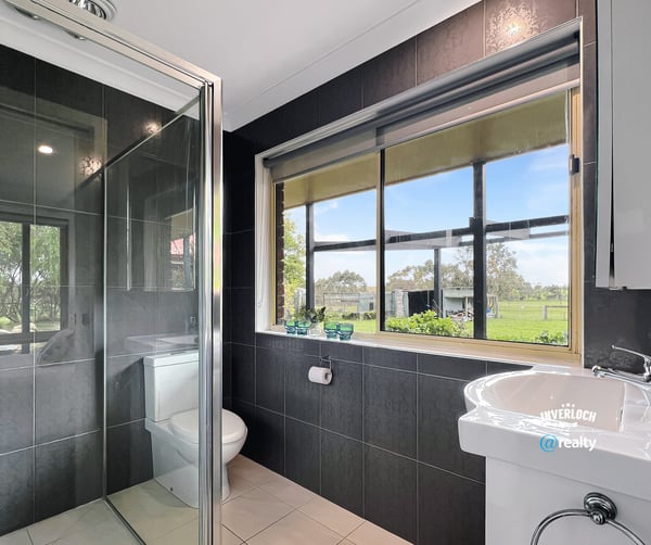 Bright bathroom featuring modern fixtures and scenic views, perfect for relaxation and comfort.