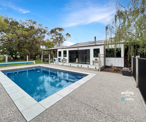 This spacious property features a large pool and versatile outdoor space, ideal for entertaining and relaxation.
