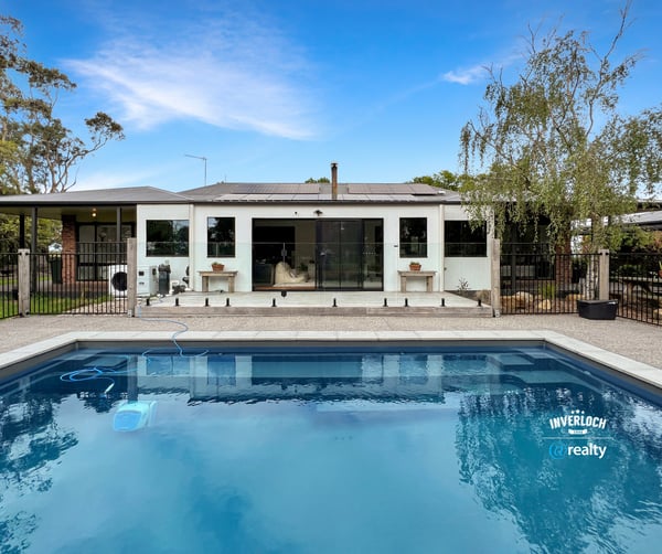 Contemporary home featuring a spacious poolside area, ideal for outdoor entertaining and relaxation.