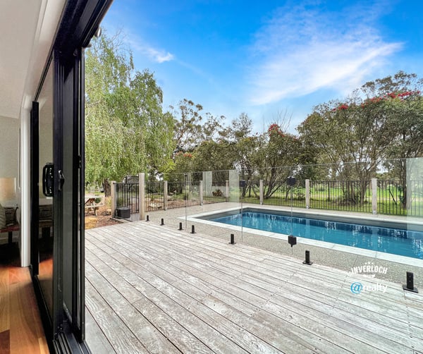 Spacious indoor-outdoor living with modern pool views, surrounded by lush greenery and serene landscapes.