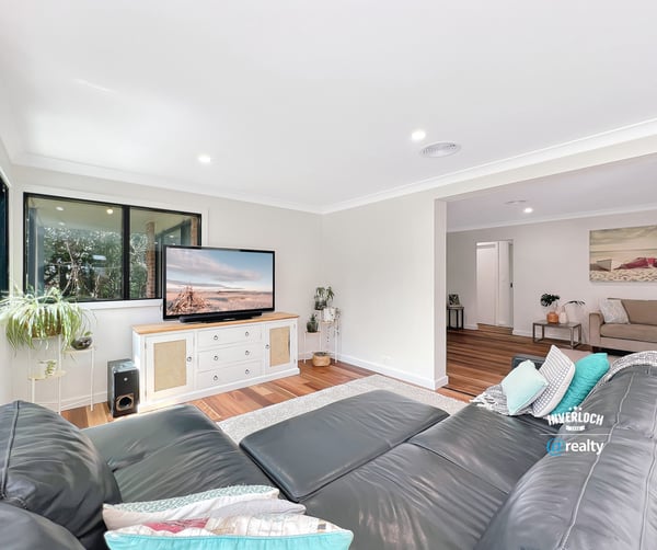 Bright and spacious living area featuring modern furnishings and large windows for natural light.