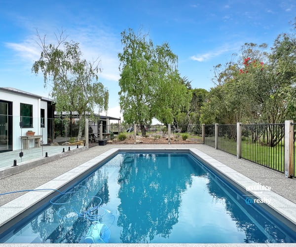 This property features a refreshing pool and landscaped yard, perfect for outdoor gatherings and relaxation.