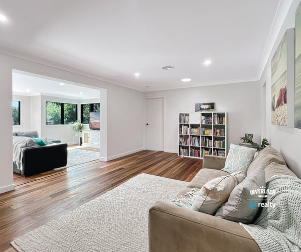 Spacious living area with modern finishes, large windows, and an inviting atmosphere perfect for relaxation.
