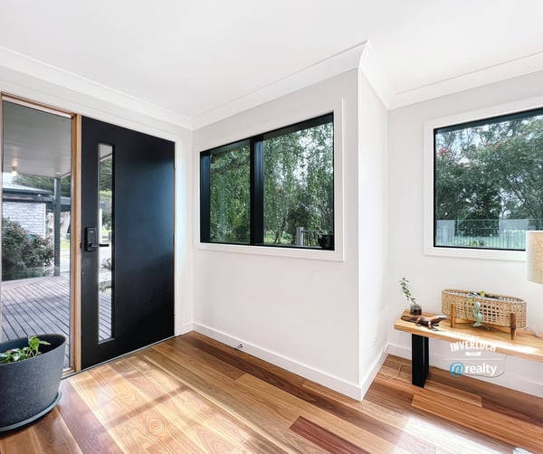 Bright entryway featuring large windows and natural light, welcoming you into a spacious home.