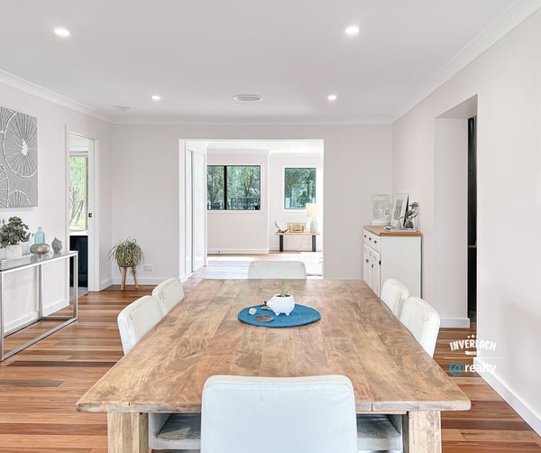 Spacious open-concept living area featuring a modern dining space and abundant natural light throughout.