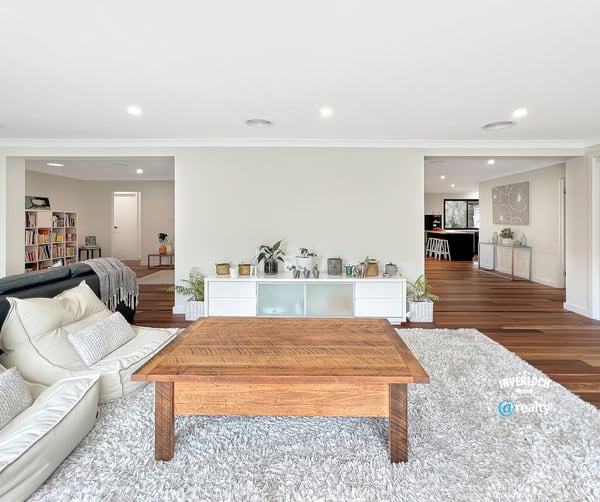 Spacious living area with modern design, featuring abundant light and seamless flow to adjacent rooms.