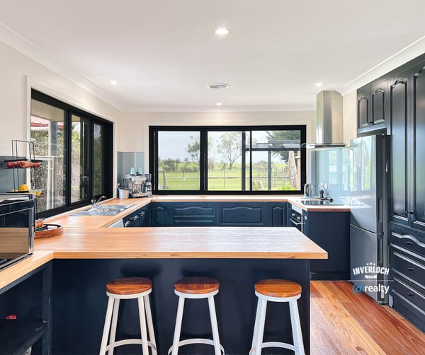 Modern kitchen featuring sleek cabinetry, expansive windows with scenic views, and a spacious island for entertaining.