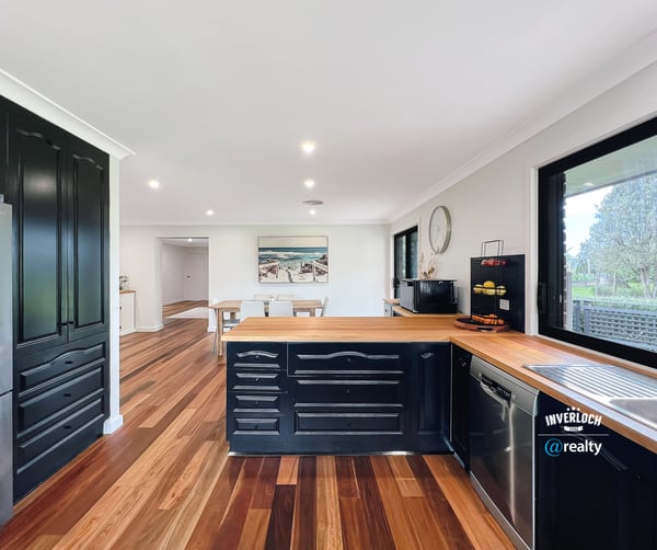 Modern kitchen featuring rich wood accents, ample counter space, and an open layout perfect for entertaining.