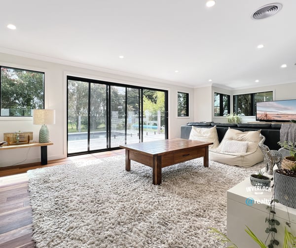 Spacious living area featuring large windows, modern furnishings, and seamless indoor-outdoor flow for relaxation and entertainment.