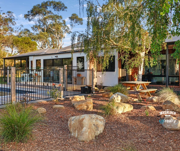 This inviting home features a spacious outdoor area with landscaped gardens and a relaxing poolside retreat.
