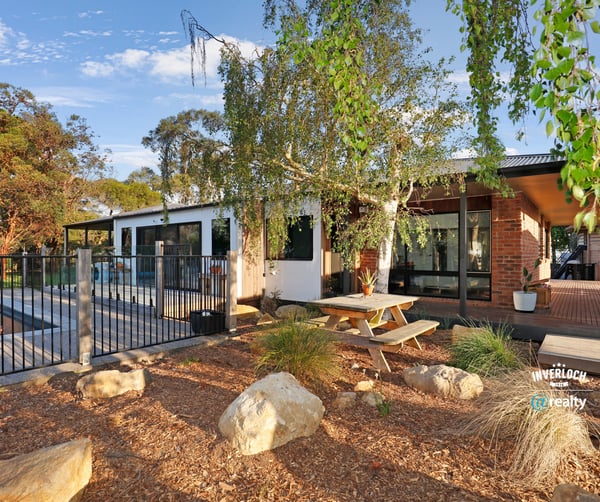 Discover this modern home featuring an inviting outdoor space, pool, and beautiful landscaping for relaxed living.