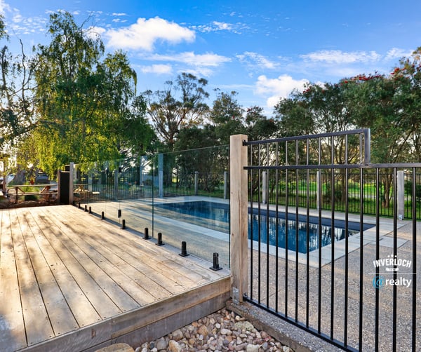 Discover a modern outdoor retreat featuring a pristine pool and expansive nature views, perfect for relaxation.