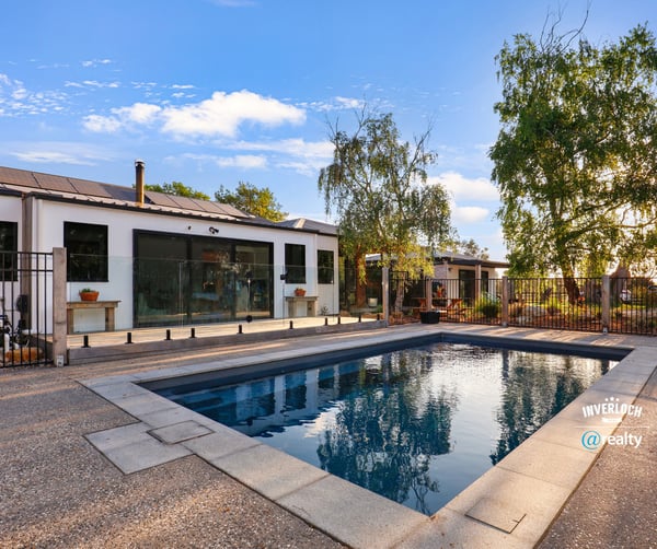 Discover a modern home featuring an inviting outdoor pool and spacious patio, perfect for entertaining.