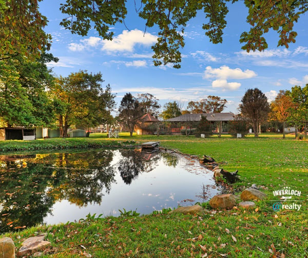 Discover a picturesque waterfront property surrounded by lush greenery and ample outdoor space for relaxation.