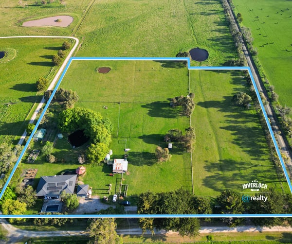 Expansive property featuring lush pastures and water features, perfect for agricultural pursuits or private retreat.