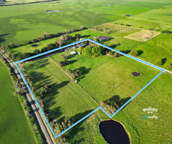 Spacious rural property featuring open fields, ponds, and mature trees, offering endless possibilities for development.