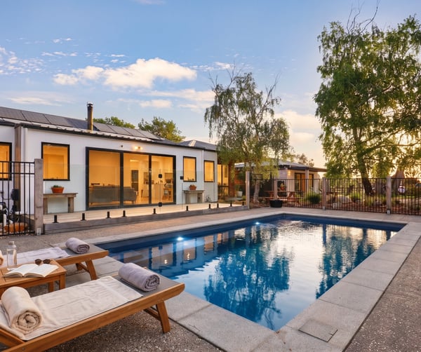 This modern home features a private pool and spacious outdoor area, perfect for entertaining and relaxation.