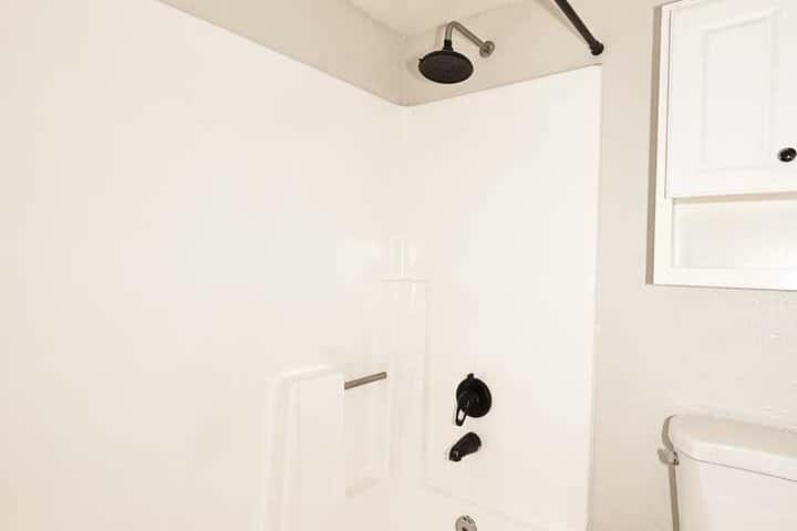 18 of 29. Bright bathroom featuring a tub and shower combination with updated fixtures and easy-care finishes. A clean, comfortable space designed for daily convenience.