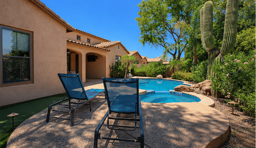 63 of 72. Lounge beside the sparkling pool from the spacious sun deck featuring comfortable seating, tropical landscaping, and a relaxing outdoor environment designed for Scottsdale living.