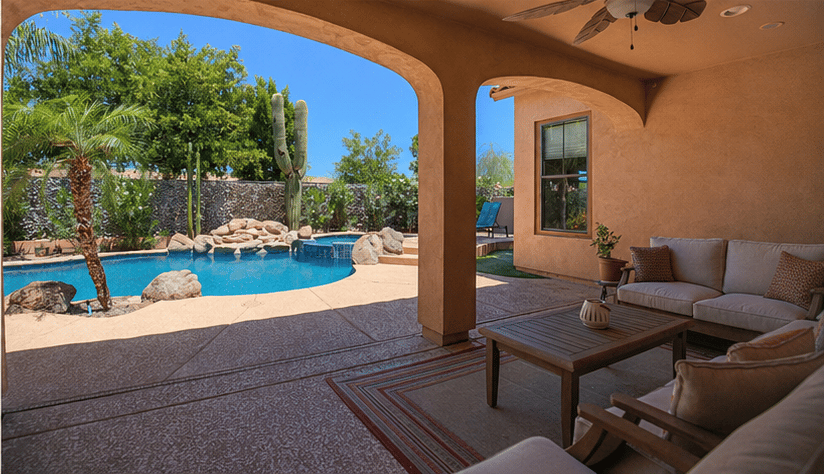 64 of 72. The covered patio creates an inviting outdoor living space with comfortable seating, pool views, shaded entertaining areas, and seamless access to the beautifully landscaped backyard.